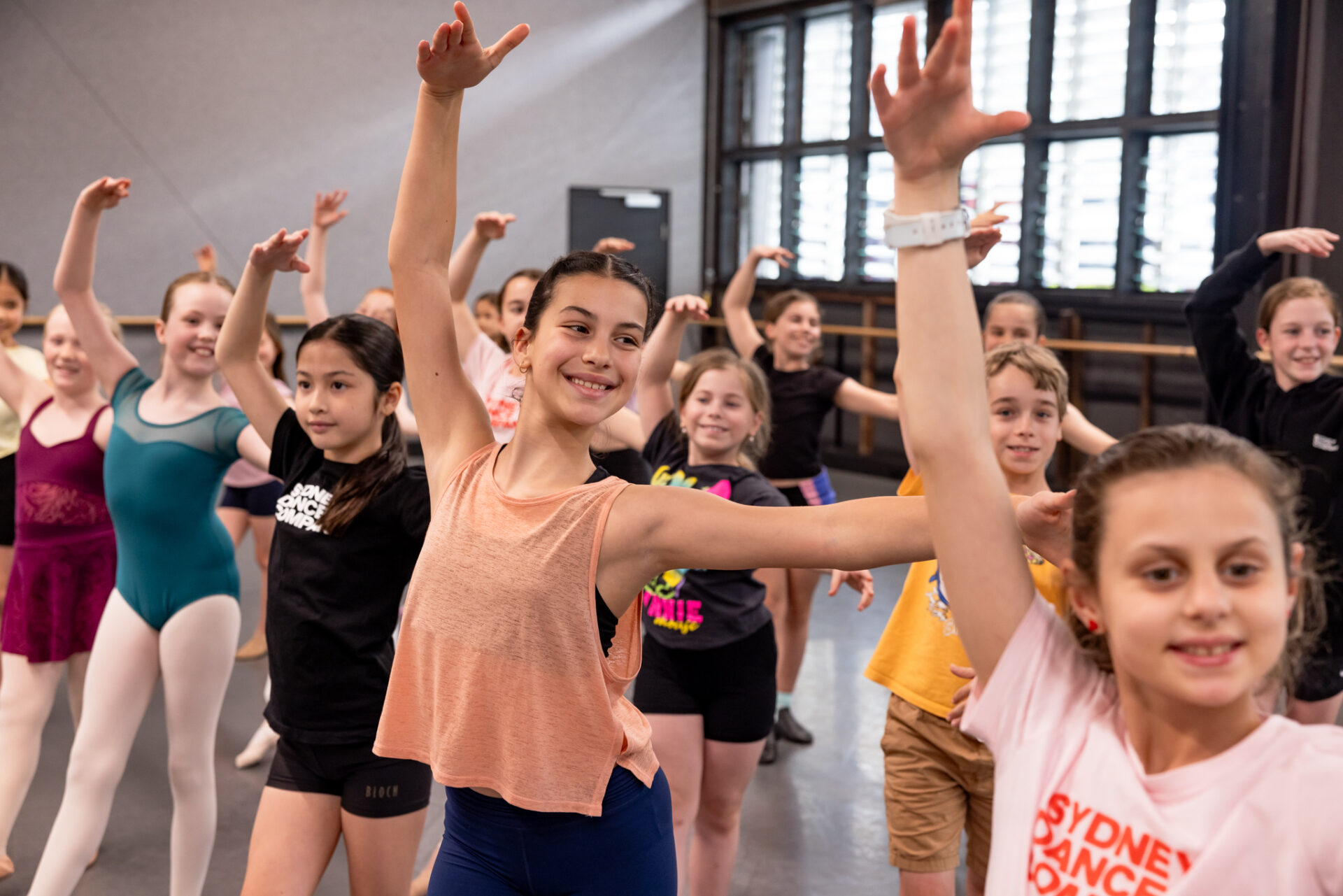 Young dancers taking a ballet class at Sydney Dance Company's School Holiday Workshops.