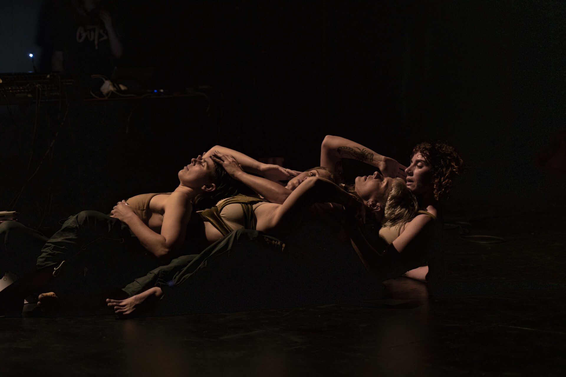 Three dancers fall backwards into each other on the ground during Ashleigh Musk's 'SUB'.